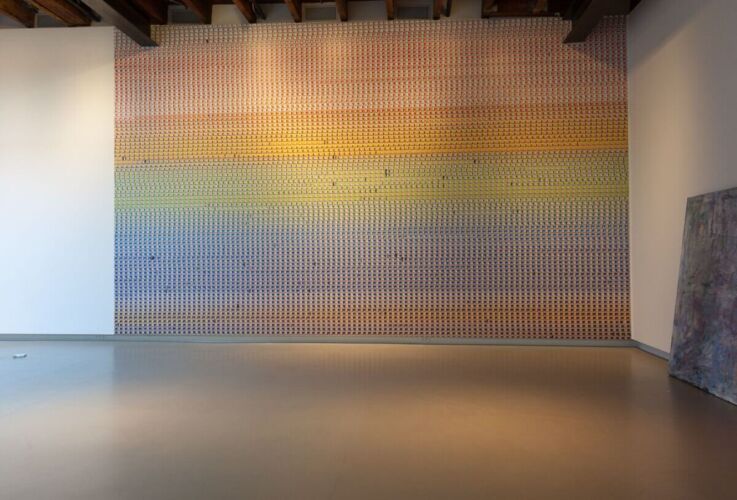 A wall mural featuring a gradient of colors arranged in a grid pattern with various shades.