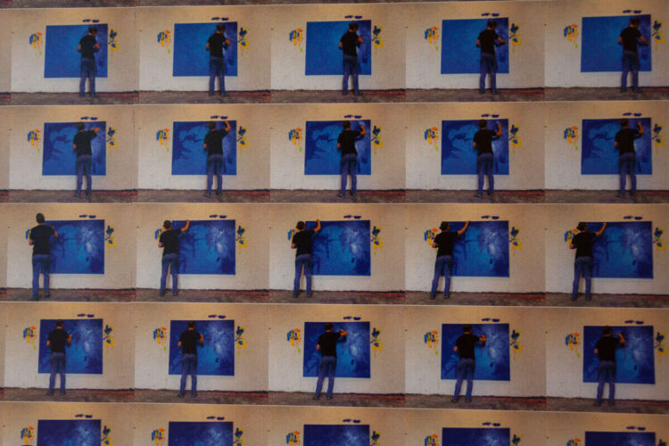 Individual painting on a blue canvas mounted on a wall in a series of images.