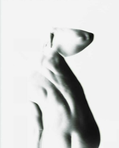 Abstract black and white image of a human figure with a smooth silhouette and no facial features.