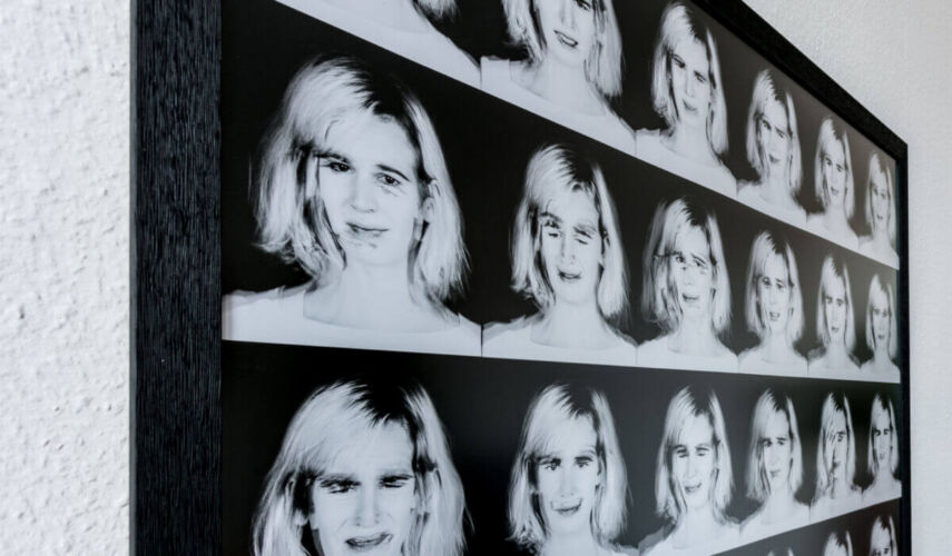 Collage of black and white portraits featuring a woman with varying expressions displayed in a grid format.