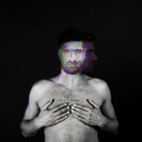 Black and white portrait of a man with a double exposure effect showing a second image of his profile.