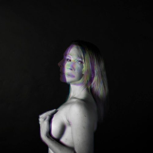 Artistic black and white portrait of a woman with a double exposure effect.