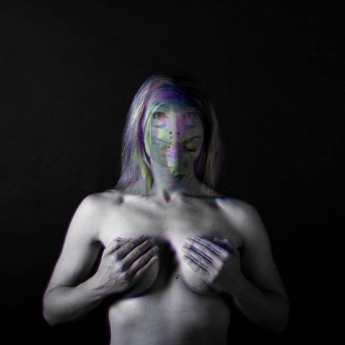 Artistic black and white portrait of a woman with abstract color effects on her face and body.