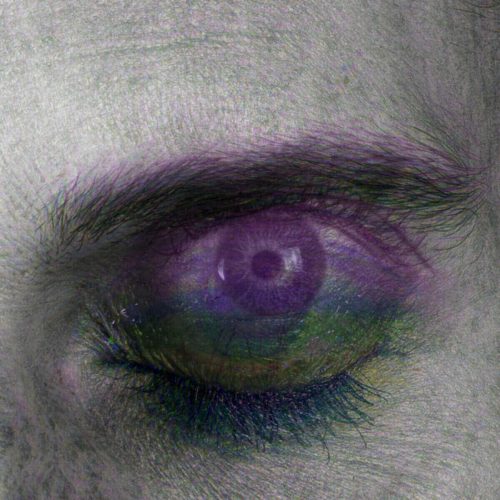 Close-up image of a human eye featuring abstract purple and green colors.