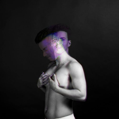 Artistic black and white portrait of a male figure with a blurred overlay effect.