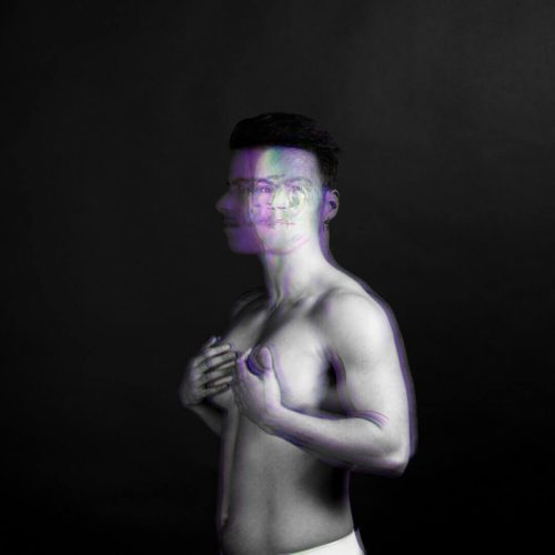 Black and white portrait of a male figure with a semi-transparent overlay effect.