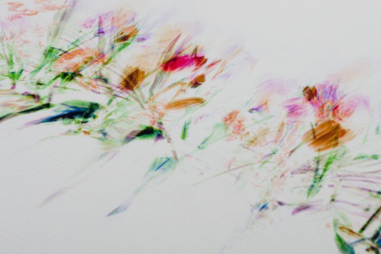 Abstract representation of flowers in vibrant colors on a textured background.